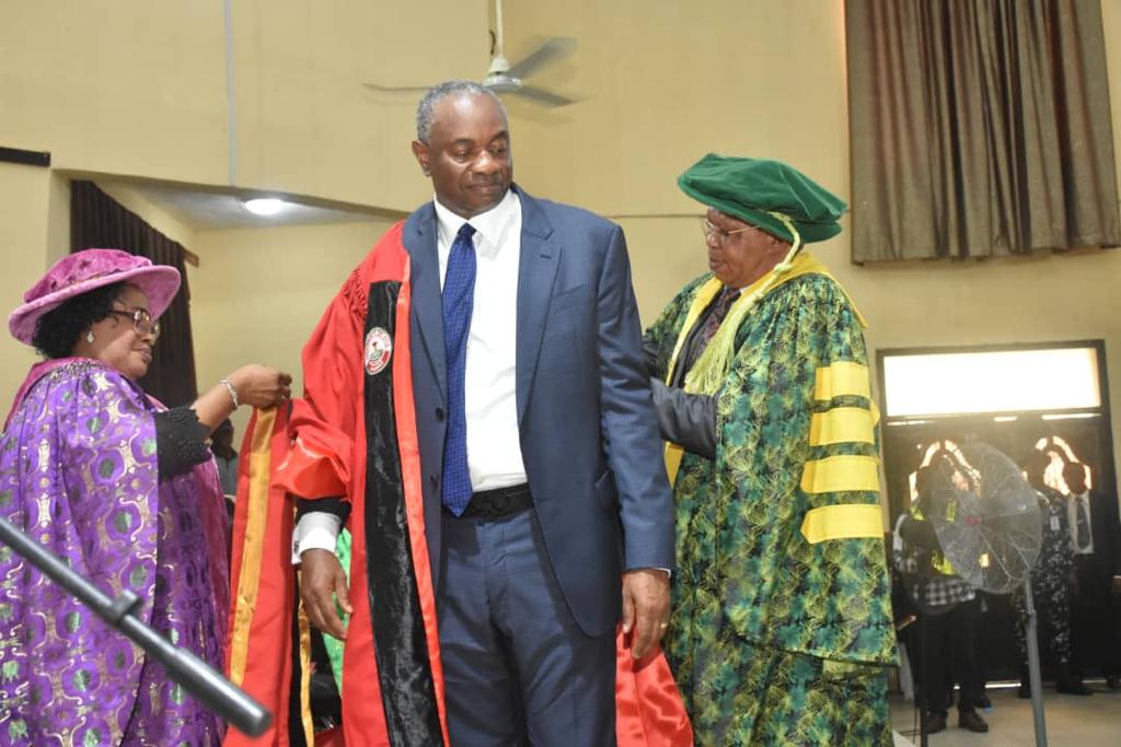 Udom Inoyo being robed by The Vice Chancellor and The Registrar of University of Uyo