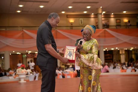 The Head Of The Civil Service of The Federation Mrs. Winifred Oyo-Ita giving a plaque to the founder of Inoyo Toro Foundation for his contribution to education